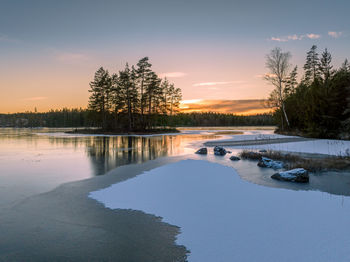 Sunset at a frozen lake in winter time