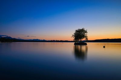 Scenic view of lake against sky during sunset