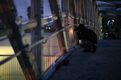 Man photographing on footbridge