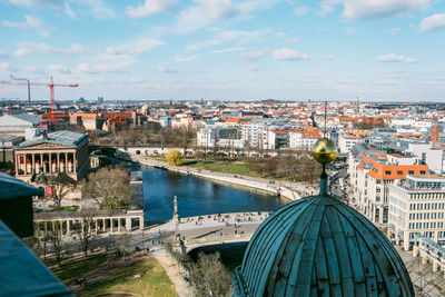 High angle view of river amidst buildings in city against sky