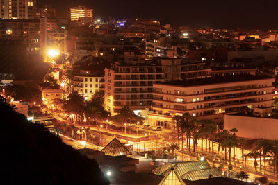 High angle view of illuminated city buildings at night