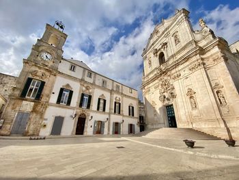 Low angle view of historic building against cloudy sky