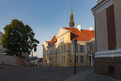 Street amidst buildings against sky in city