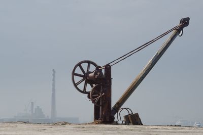 Crane at construction site against clear sky