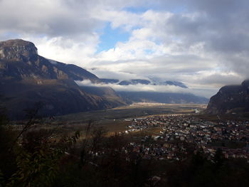 Scenic view of townscape and mountains against sky