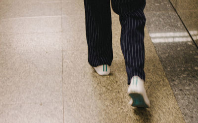 Low section of woman walking outdoors