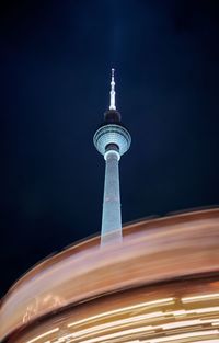 Low angle view of illuminated berlin tower against sky at night