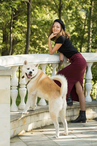 Portrait of young woman with dogs in park