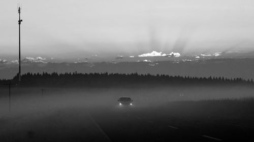 Scenic view of lake against sky during foggy weather