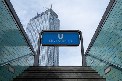 Low angle view of text on building against sky