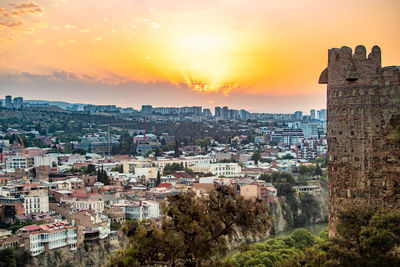 High angle view of buildings against sky at sunset