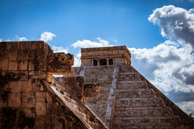 Low angle view of old building against cloudy sky