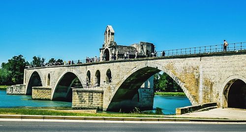 Arch bridge against clear blue sky