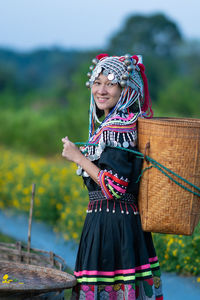 Young woman smiling while standing on field