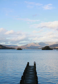 Pier over lake against sky