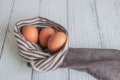 High angle view of eggs in basket on table