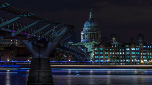 Light trails over thames river by st paul cathedral at night