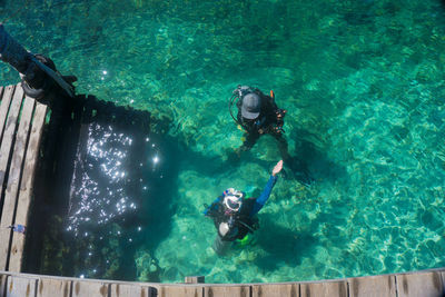 High angle view of scuba divers in sea