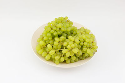 Close-up of grapes over white background