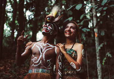 Portrait of a smiling young woman in forest