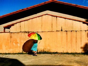 Full length of a woman with umbrella outdoors