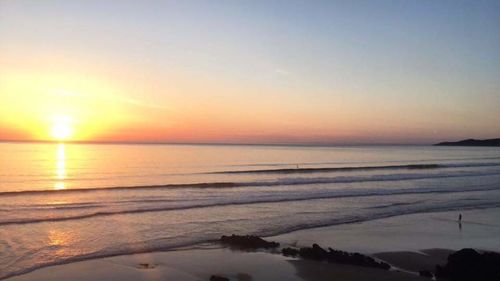 Scenic view of sea against sky at sunset