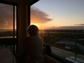 Rear view of woman looking at sunset