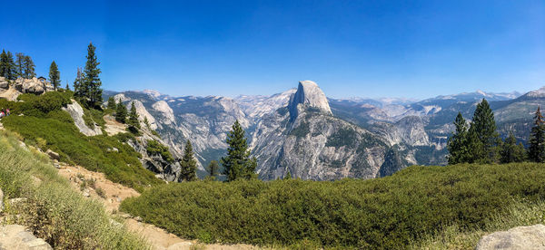 Scenic view of mountains against blue sky