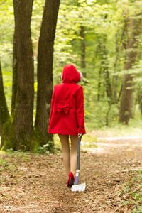 Rear view of fashion model walking in forest