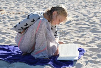 Young woman sitting on beach