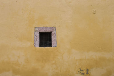 Low angle view of window on wall of building