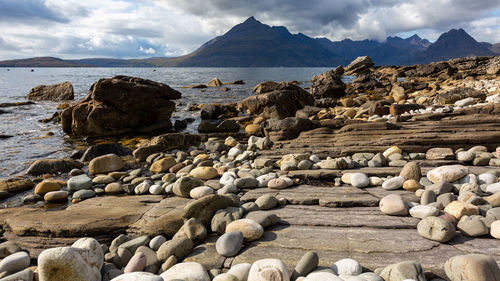 Rocks on beach against sky