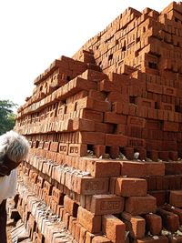 Full frame shot of brick wall with building in background