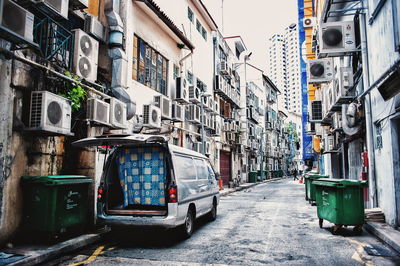 Van parked on street amidst residential buildings