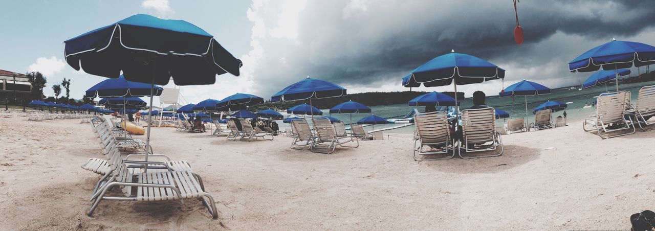 beach, beach umbrella, sand, sun lounger, vacations, chair, protection, outdoors, day, summer, canopy, shelter, nature, group of objects, sky, no people, water, tent, folding chair, sea