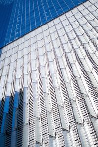 Low angle view of modern glass building in city