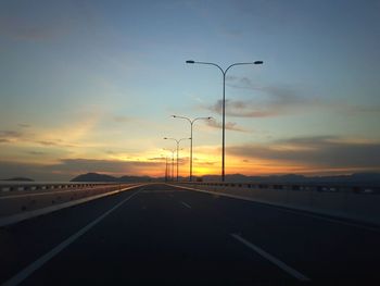 Street against sky during sunset