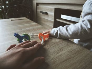 Close-up of baby hand on table