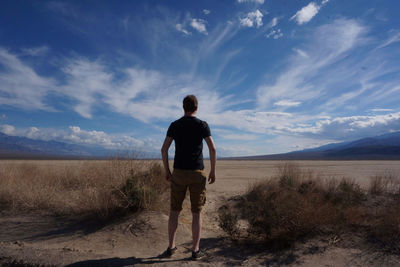 Rear view of man standing in the desert