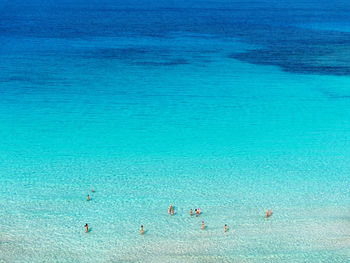 High angle view of people swimming in sea