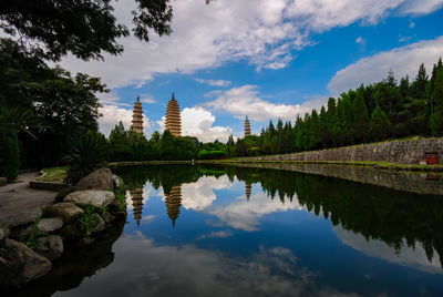 Scenic view of lake by buildings against sky