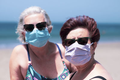 Portrait of women wearing sunglasses against sky