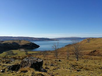 Scenic view of land against clear blue sky