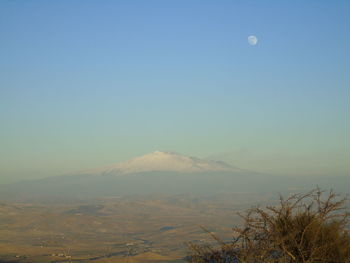 Scenic view of mountains against clear blue sky