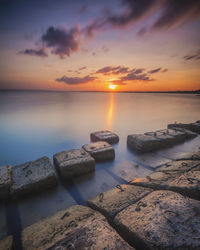 Scenic view of sea against sky during sunset