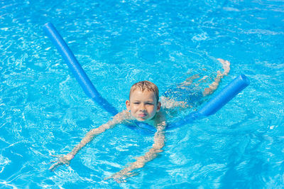 Portrait of boy swimming in pool