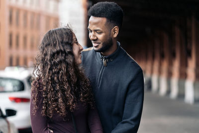Young couple standing in city