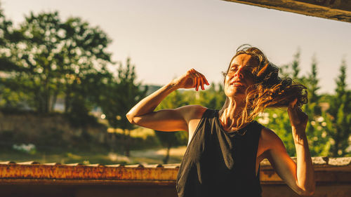 Woman dances at sunset