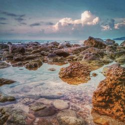 Scenic view of sea against cloudy sky