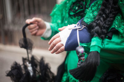 Midsection of women in green costume